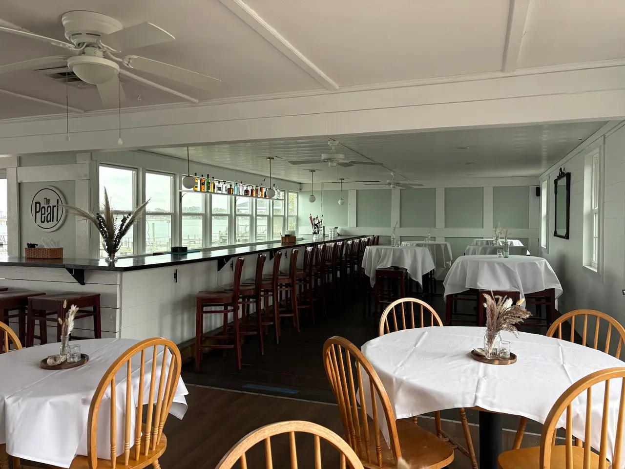 The bar and dining room with windows on the water